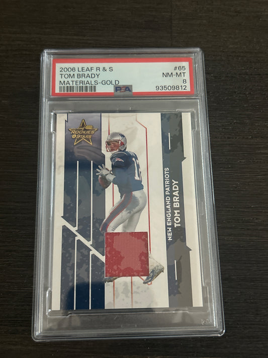 2006 Leaf Rookies & Stars Tom Brady Game-Used Jersey Materials Gold – PSA 8 NM-MT